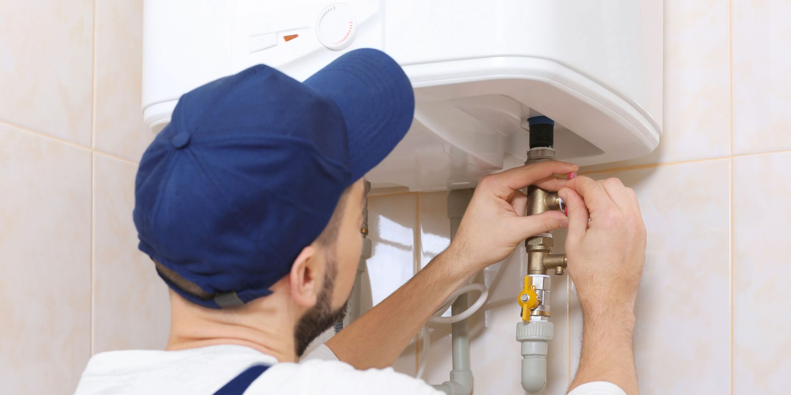 fps-plumbing-geyser-valve-fitting Plumber adjusting a valve fitting on a household geyser
