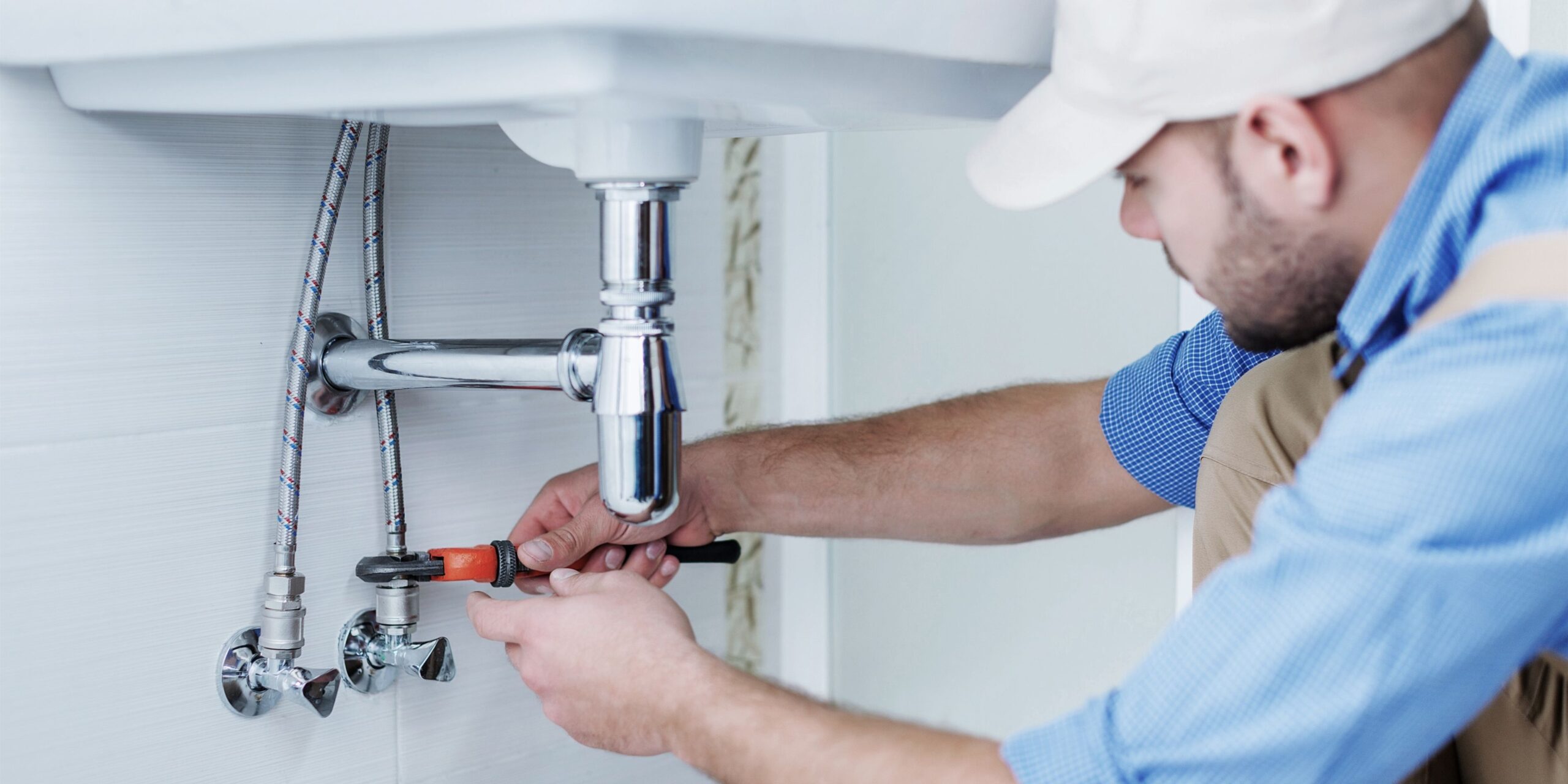 fps-plumbing-blocked-drain-pipe-fitting Plumber loosening a pipe fitting to clear a blocked drain